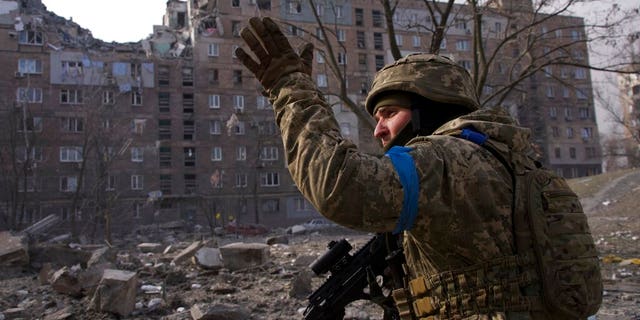 A Ukrainian serviceman guards his position in Mariupol, Ukraine, Saturday, March 12, 2022. (AP Photo/Mstyslav Chernov)