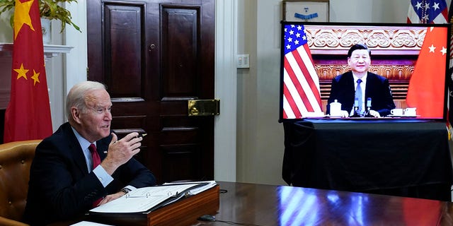 FILE - President Biden meets virtually with Chinese President Xi Jinping from the Roosevelt Room of the White House in Washington, on Nov. 15, 2021. 