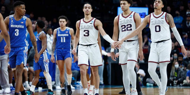 Gonzaga guard Andrew Nembhard (3), forward Anton Watson (22) and guard Julian Strawther (0) react during the second half of a second-round NCAA Tournament game against Memphis March 19, 2022, in Portland, Ore. Gonzaga won 82-78.
