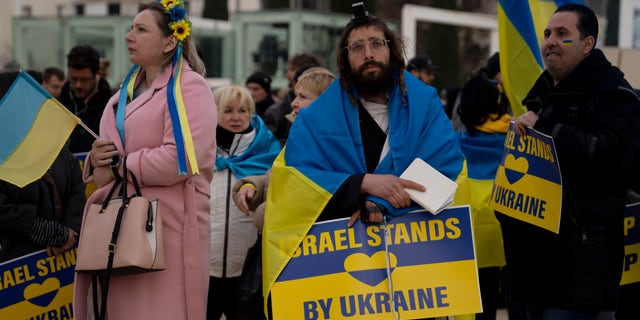 People gather in Habima Square in Tel Aviv, Israel, to watch Ukrainian President Volodymyr Zelenskyy in a video address to the Knesset, Israel's parliament