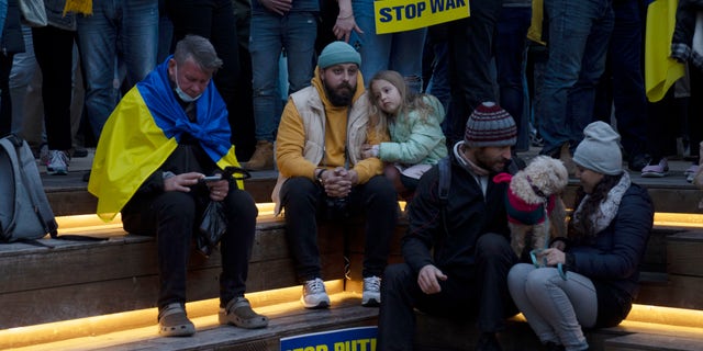 People gather in Habima Square in Tel Aviv, Israel, to watch Ukrainian President Volodymyr Zelenskyy in a video address to the Knesset, Israel's parliament