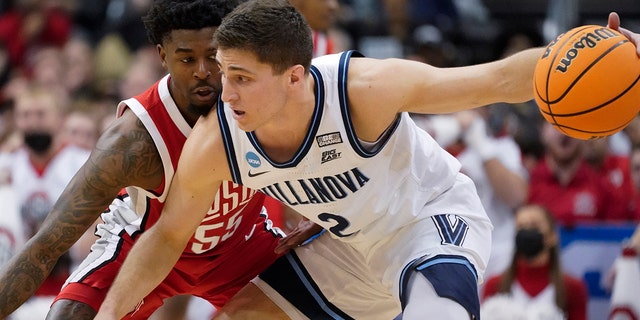 Villanova's Collin Gillespie (2) tries to get the ball past Ohio State's Jamari Wheeler (55) during the first half of a college basketball game in the second round of the NCAA tournament, Sunday, March 20, 2022, in Pittsburgh.