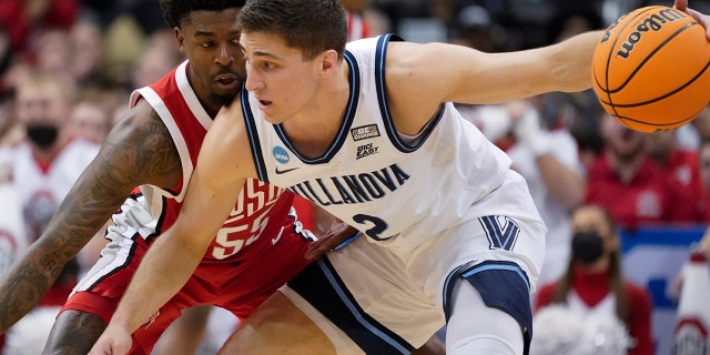 Villanova's Collin Gillespie (2) tries to get the ball past Ohio State's Jamari Wheeler (55) during the first half of a college basketball game in the second round of the NCAA tournament, Sunday, March 20, 2022, in Pittsburgh.