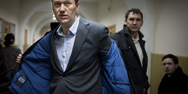 Alexei Navalny taking off his coat