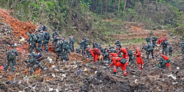 In this photo released by Xinhua News Agency, rescue workers search for the black boxes at a plane crash site in Tengxian county, southwestern China's Guangxi Zhuang Autonomous Region, Tuesday, March 22, 2022.