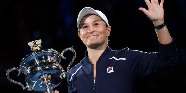 Ash Barty of Australia waves as she holds the Daphne Akhurst Memorial Cup after defeating Danielle Collins of the U.S., in the women's singles final at the Australian Open tennis championships in Melbourne, Australia on Jan. 29, 2022.