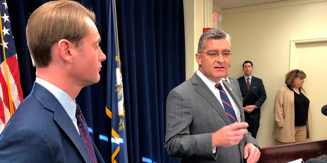 Republican state Sen. Robby Mills, right, discusses his bill in Frankfort, Ky., that would require Kentuckians to present photo identification in order to vote on Jan. 8, 2020. 
