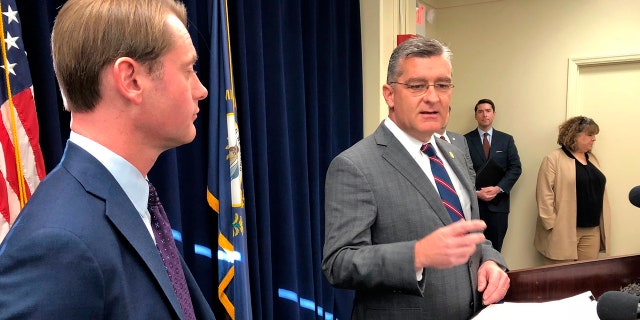 Republican state Sen. Robby Mills, right, discusses his bill in Frankfort, Ky., that would require Kentuckians to present photo identification in order to vote on Jan. 8, 2020.