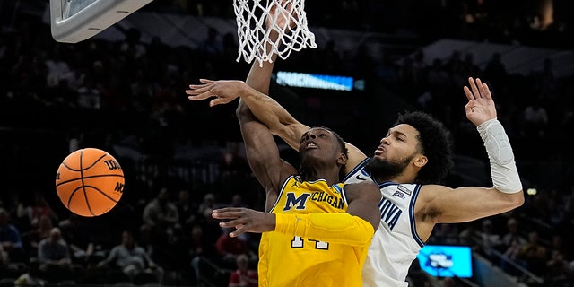 Villanova guard Caleb Daniels, right, fouls Michigan forward Moussa Diabate during the second half of a college basketball game in the Sweet 16 round of the NCAA tournament on Thursday, March 24, 2022, in San Antonio.