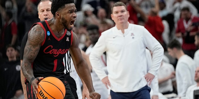Houston guard Jamal Shead celebrates after scoring as Arizona head coach Tommy Lloyd looks on during the second half of a college basketball game in the Sweet 16 round of the NCAA tournament on Thursday, March 24, 2022, in San Antonio.