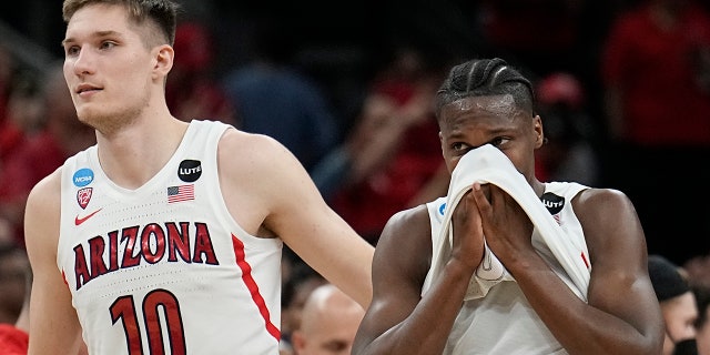 Arizona forward Azuolas Tubelis and guard Bennedict Mathurin leave the court after their loss to Houston in a college basketball game in the Sweet 16 round of the NCAA tournament on Thursday, March 24, 2022, in San Antonio.