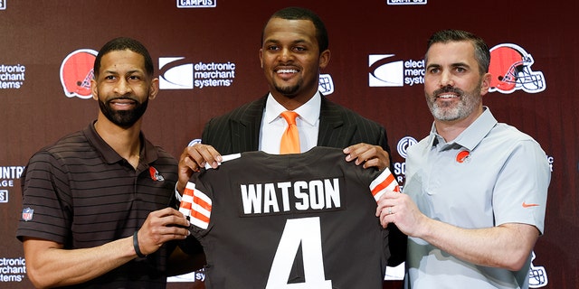 Cleveland Browns general manager Andrew Berry, left, new quarterback Dashon Watson, in the center, and head coach Kevin Stefansky pose for a photo during a press conference at the NFL football team's training base on Friday, March 25, 2022, in Bera, Ohio. 
