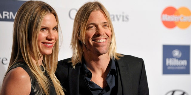 FILE - Foo Fighters drummer Taylor Hawkins, right, and Alison Hawkins arrive at the Clive Davis Pre-GRAMMY Gala on Saturday, Feb. 9, 2013, in Beverly Hills, Calif. Taylor’s wife, Alison, took to social media to thank the band and its fans for their support.