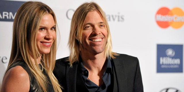 FILE - Foo Fighters drummer Taylor Hawkins, right, and Alison Hawkins arrive at the Clive Davis Pre-GRAMMY Gala on Saturday, Feb. 9, 2013, in Beverly Hills, Calif. Taylor’s wife, Alison, took to social media to thank the band and its fans for their support.