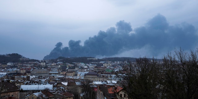 Smoke rises in the sky in Lviv, western Ukraine, Saturday, March 26, 2022. (AP Photo/Nariman El-Mofty)