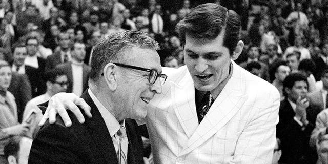 UCLA Bruins coach John Wooden, left, is congratulated by Jacksonville coach Joe Williams after UCLA beat the Dolphins, 80-69, in the national championship March 21, 1970, in College Park, Md.