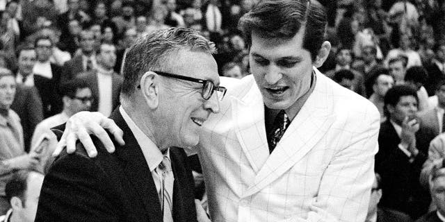 UCLA Bruins coach John Wooden, left, is congratulated by Jacksonville coach Joe Williams after UCLA beat the Dolphins, 80-69, in the national championship March 21, 1970, in College Park, Md.