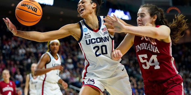Connecticut forward Olivia Nelson-Ododa reaches for a rebound against Indiana's Mackenzie Holmes in the Sweet Sixteen round of the NCAA women's tournament, Saturday, March 26, 2022, in Bridgeport, Connecticut.