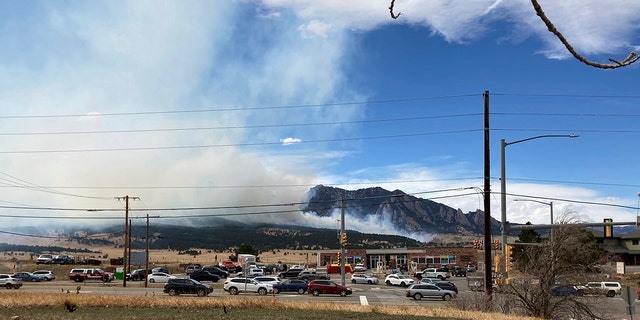 Smoke billows from a wildfire Saturday, March 26, 2022 in Marshall, Colo., a few miles south of Boulder, Colo.  (AP Photo/Dave Zelio)