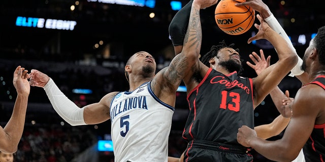 Villanova guard Justin Moore, left, vies for the ball with Houston forward J'Wan Roberts during the Elite Eight of the NCAA Tournament March 26, 2022, in San Antonio.