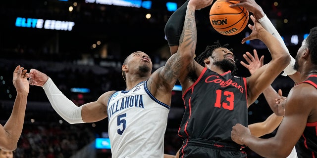 Villanova guard Justin Moore, left, vies for the ball with Houston forward J'Wan Roberts during the Elite Eight of the NCAA Tournament March 26, 2022, in San Antonio.