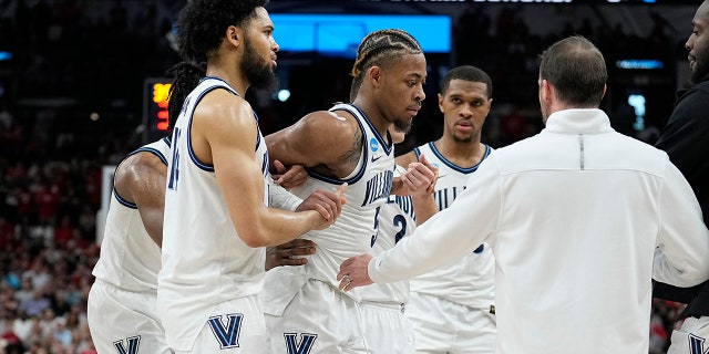 Villanova guard Justin Moore was later seen on crutches during the Wildcats' postgame celebration on Saturday, March 26, 2022, in San Antonio.