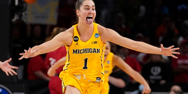 Michigan's Amy Dilk (1) celebrates a 52-49 victory over South Dakota following a game in the Sweet 16 round of the NCAA women's tournament Saturday, March 26, 2022, in Wichita, Kan.