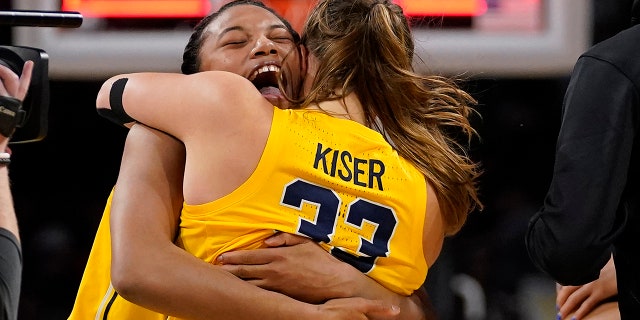Michigan's Naz Hillmon, left, and Emily Kiser celebrate a 52-49 victory over South Dakota in the Sweet 16 round of the NCAA women's tournament Saturday, March 26, 2022, in Wichita, Kan.