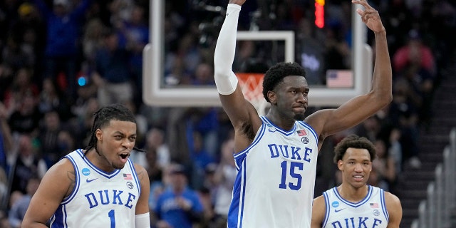 Duke guard Trevor Keels (1) celebrates with center Mark Williams (15) and forward Wendell Moore Jr. (0) during the second half of a college basketball game against Arkansas in the Elite 8 round of the NCAA men's tournament in San Francisco, Saturday, March 26, 2022. (AP Photo/Tony Avelar)