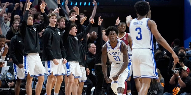 Duke forward AJ Griffin (21) celebrates in front of teammates on the bench after shooting a three point basket against Arkansas during the second half of a college basketball game in the Elite 8 round of the NCAA men's tournament in San Francisco, Saturday, March 26, 2022. (AP Photo/Marcio Jose Sanchez)
