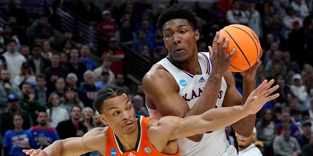 Kansas' David McCormack tries to get past Miami's Isaiah Wong during the Elite 8 round of the NCAA tournament Sunday, March 27, 2022, in Chicago.
