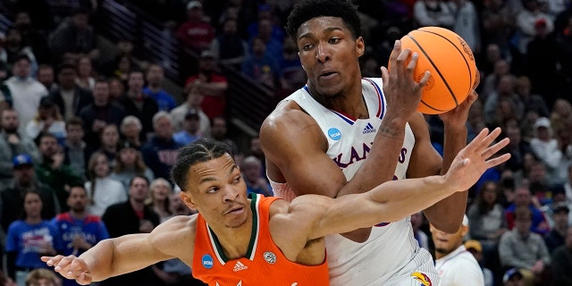Kansas' David McCormack tries to get past Miami's Isaiah Wong during the Elite 8 round of the NCAA tournament Sunday, March 27, 2022, in Chicago.
