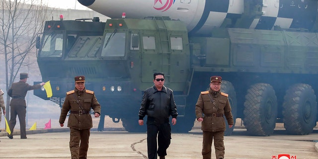 FILE - In this photo distributed by the North Korean government, North Korean leader Kim Jong Un, center, walks around what it says a Hwasong-17 intercontinental ballistic missile (ICBM) on the launcher, at an undisclosed location in North Korea on March 24, 2022. Independent journalists were not given access to cover the event depicted in this image distributed by the North Korean government.