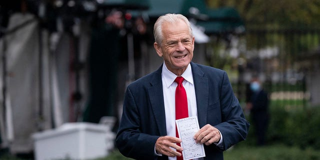 White House trade adviser Peter Navarro holds his notes after a television interview at the White House, Monday, Oct. 12, 2020, in Washington. 