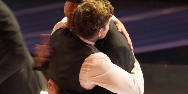 Bradley Cooper, left, and Will Smith appear in the audience at the Oscars on Sunday, March 27, 2022. (AP Photo/Chris Pizzello)