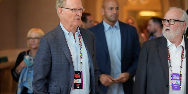New York Giants co-owner, president and CEO John Mara, front left, arrives for a presentation at the start of the NFL football owners meeting, Sunday, March 27, 2022, at The Breakers resort in Palm Beach, Fla.