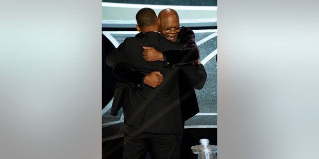 Will Smith and Samuel L. Jackson hug in the audience as Will Smith is announced the winner of the award for best performance by an actor in a leading role for "King Richard" at the Oscars on Sunday, March 27, 2022. (AP Photo/Chris Pizzello)