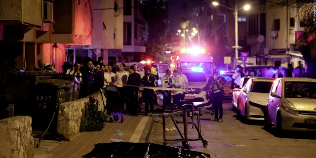 Israel: Terror group claims responsibility for motorcyclist gunman who killed 5 people Ultra-Orthodox Jews stand near the covered body of a shooting victim in Bnei Brak, Israel, Tuesday, March 29, 2022.