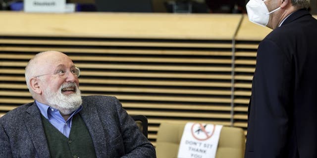 EU Commissioner for Economy Paolo Gentiloni (right) speaks with EU Commissioner for European Green Deal Frans Timmermans (left) during the European Commission weekly College Meeting at the EU headquarters in Brussels, Wednesday, March 30, 2022.