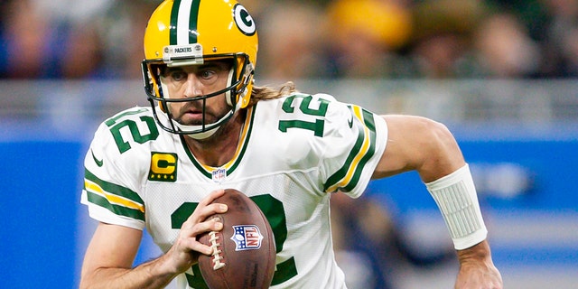 Green Bay Packers quarterback Aaron Rodgers (12) runs the ball during the first quarter against the Detroit Lions at Ford Field on Jan. 9, 2022, in Detroit, Michigan.