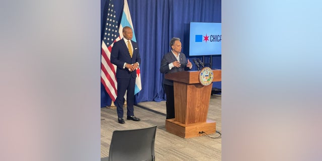 New York City Mayor Eric Adams stands behind Chicago Mayor Lori Lightfoot during a joint news conference Friday. The pair met to discuss ways to combat a violent crime wave in both cities.   
