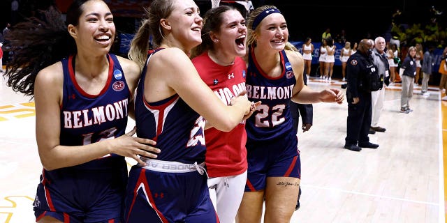 Belmont guard Kilyn McGuff (12), guard Nikki Baird (23) and forward Tessa Miller (22) celebrate with a teammate after a double-overtime win in a college basketball game against Oregon in the first round of the NCAA tournament, Saturday, March 19, 2022, in Knoxville, Tenn.