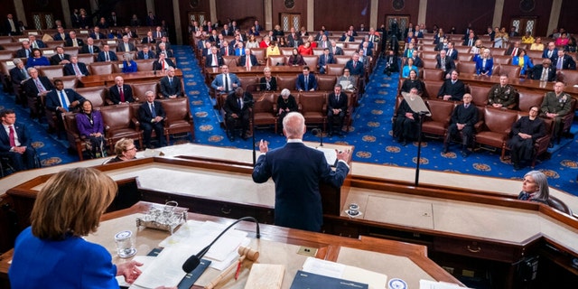 President Joe Biden delivers his first State of the Union address to a joint session of Congress at the Capitol, Tuesday, March 1, 2022, in Washington, as House Speaker Nancy Pelosi looks at a copy of Biden's speech at left.