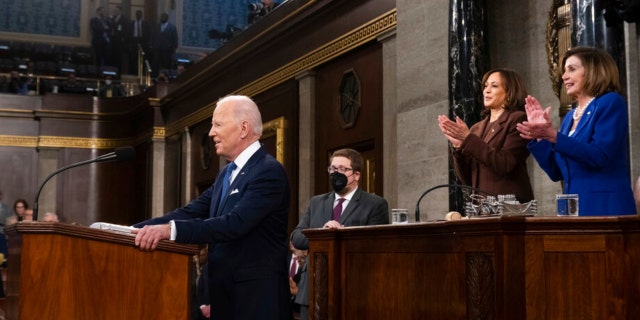 President Biden arrives to deliver his first State of the Union address to a joint session of Congress on at the Capitol, Tuesday, March 1, 2022, in Washington, as Vice President Kamala Harris and House Speaker Nancy Pelosi applaud.