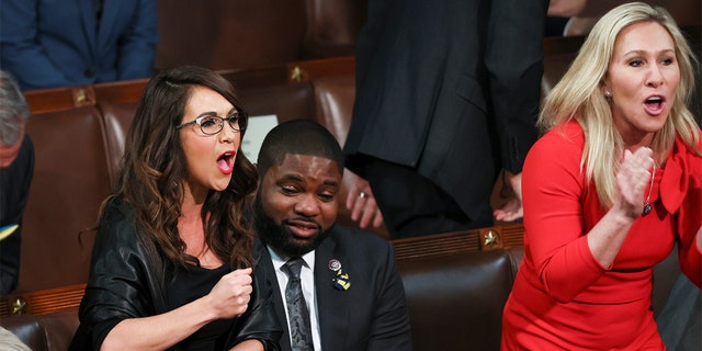 Rep. Lauren Boebert, R-Colo., left, and Rep. Marjorie Taylor Greene, R-Ga., right, scream "Build the Wall" as President Biden delivers his first State of the Union address to a joint session of Congress at the Capitol, Tuesday, March 1, 2022, in Washington. 
