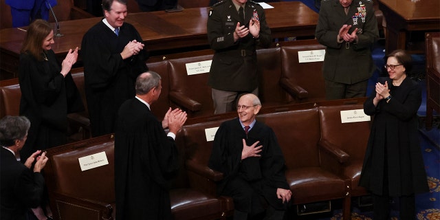 Stephen Breyer, associate justice of the U.S. Supreme Court, center, reacts as President Biden honors Breyer during a State of the Union address at the U.S. Capitol in Washington, Tuesday, March 1, 2022.