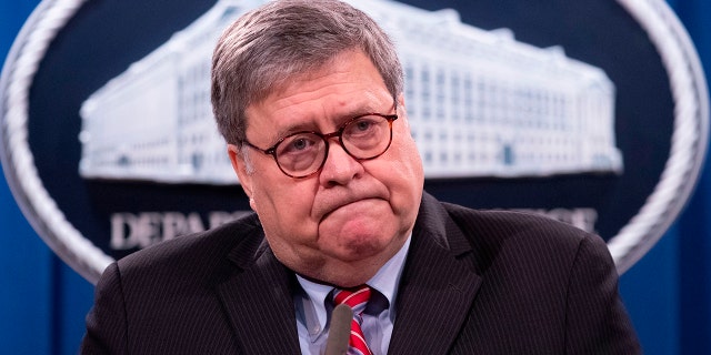 Attorney General Bill Barr looks on during a news conference at the Department of Justice in Washington, Dec. 21, 2020.