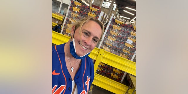 Billie Jauss at City Harvest NYC with other Mets wives packing fruit boxes. 