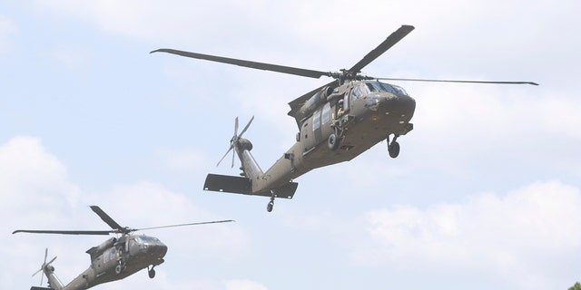 FILE - Two UH-60 Black Hawk helicopter assigned to the 2nd Assault Helicopter Battalion, 82nd Combat Aviation Brigade prepare to land on flight strip 2 to perform sling load operations with students assigned to the DeGlopper Air Assault School, XVIII Airborne Corps on Fort Bragg, N.C., April 20.