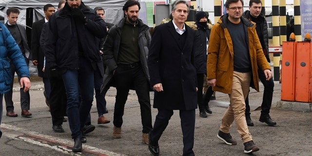 U.S. Secretary of State Antony Blinken, center, and Ukrainian Foreign Minister Dmytro Kuleba, second right, walk together after meeting at the Ukrainian-Polish border crossing in Korczowa, Poland, Saturday, March 5, 2022. 